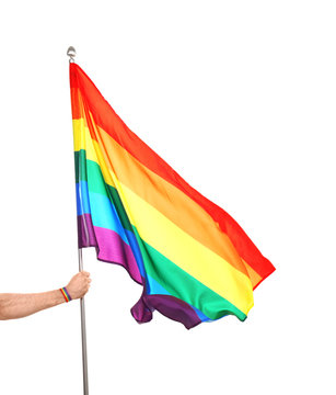 Gay man holding rainbow LGBT flag on white background