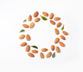 Frame made of organic almond nuts on white background. Space for text