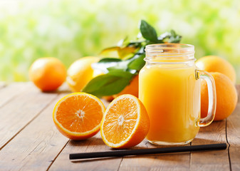 glass jar of fresh orange juice with fresh fruits