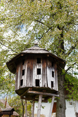 Old traditional ukrainian wooden beehive with tree background