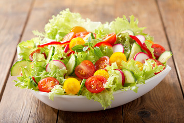 bowl of fresh salad with vegetables and greens