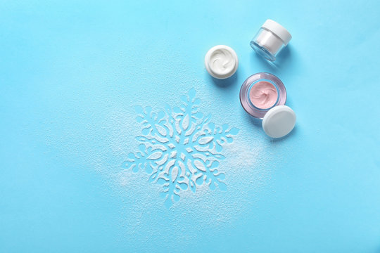 Set of cosmetic products on blue background, flat lay. Winter care