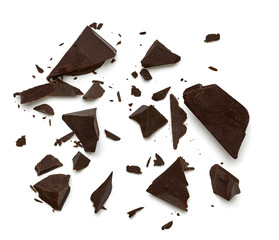 Broken, cracked or crushed dark chocolate parts from top view isolated on white background