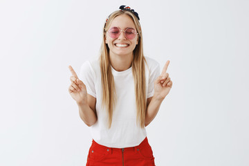 What pleasure being number one. Portrait of grinning optimistic and playful young blond woman in...