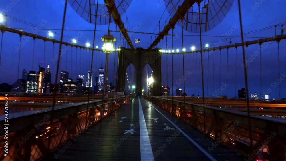 Wall mural Walking in Brooklyn bridge at night