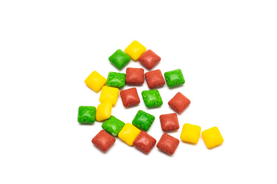 A pile of multi colored square candies