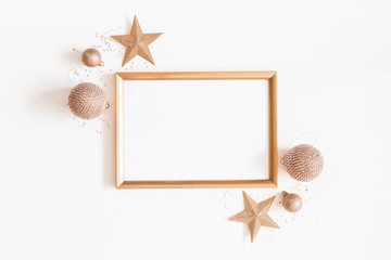 Christmas composition. Photo frame, golden decorations on white background. Christmas, winter, new...