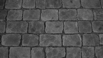 Stone pavement texture black and white. cobblestone background