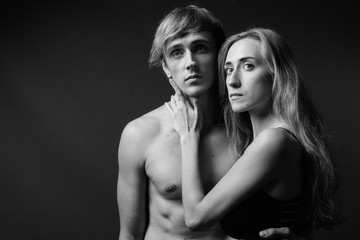 Studio shot of young couple together in black and white