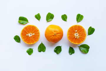 Fresh oranges with half of Bergamot kaffir lime leaves, heart shape on white background