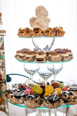 Many different desserts in on three floor glass plates