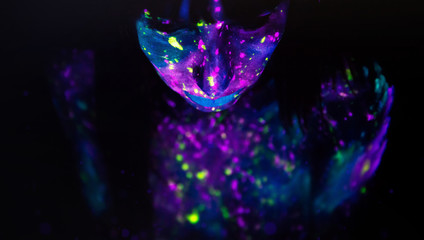 Bodypainting on nude girl painted with UV colors