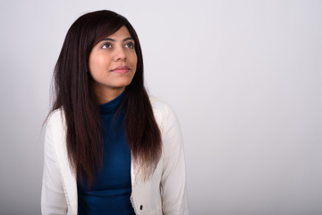 Close up of young Persian businesswoman thinking while looking u