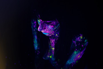 Bodypainting on nude girl painted with UV colors