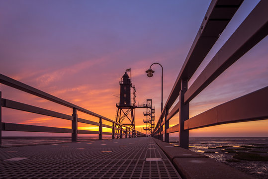 The former lighthouse Eversand-Oberfeuer built in 1886/87 is now a museum and a tourist attraction. Here during the sunset. Concept: travel and vacation