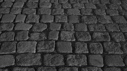 Stone pavement texture black and white. cobblestone background