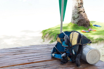 Full set of scuba diving equipment and snorkeling on shore on the wood boards. Background with copy...