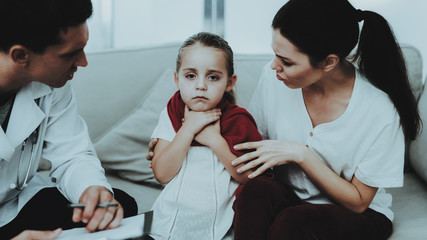 Doctor Visiting Little Girl in Red Scarf with Cold