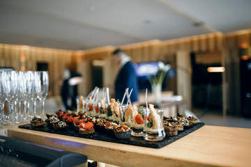 catering services background with snacks and glasses of wine on bartender counter in restaurant