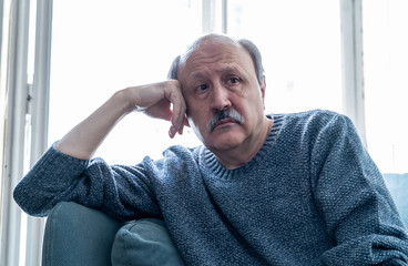 Depressed overwhelmed old man feeling exhausted alone and unhappy suffering from depression