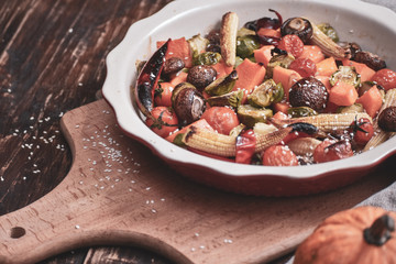 Grilled vegetables. Lenten menu. Appetizing eggplant, pepper, beetroot, tomato and patisson on plate. Fork, knife, napkin.Copy space