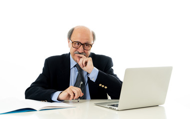 Overwhelmed and tired old businessman working with laptop feeling angry at office