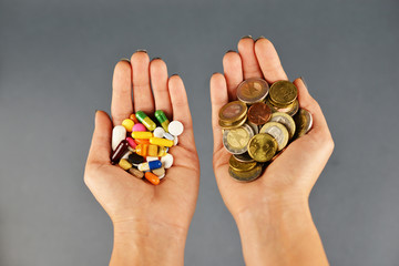 Fototapeta na wymiar Expensive treatment concept with piles of cash money and pharmaceutical drugs in woman hands