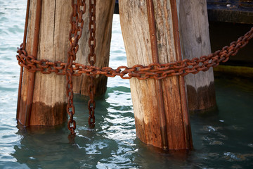 Fototapeta premium massive thick poles pier rusty chain