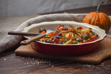 Grilled vegetables. Lenten menu. Appetizing eggplant, pepper, beetroot, tomato and patisson on plate. Fork, knife, napkin.Copy space