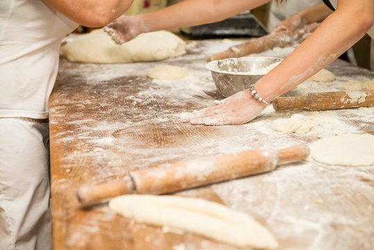 Young children make dough products. Hands closeup