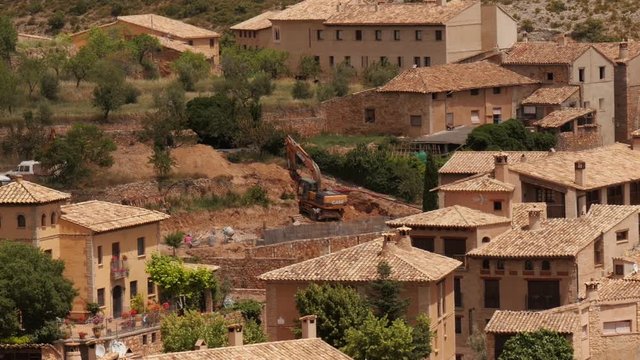 excavator in historic village of Alqu&eacute;zar, Huesca Aragon, Spain