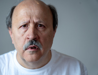 Portrait of disorientated and confused old man suffering from Alzheimer