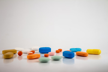 Drugs in the form of pills of different sizes, shapes and colors.