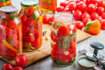 Homemade pickled tomatoes in jar. Selective focus.