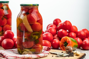 Homemade pickled tomatoes in jar. Selective focus.