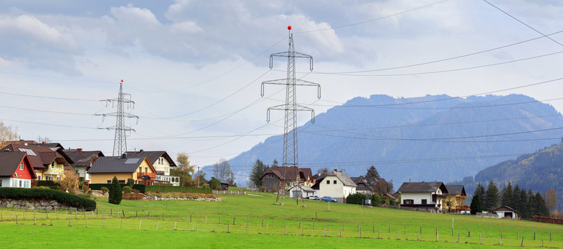 Panoramic view of the alpine village Unterburg with the power transmission line tower in the foreground. Styria, Austria, Europe.