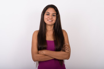 Studio shot of young happy Indian woman smiling while wearing sl