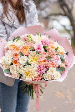 Beautiful spring bouquet in woman hand. Arrangement with various flowers. The concept of a flower shop. A set of photos for a site or catalogue. Work florist.