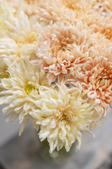 chrysanthemum yellow and pink pastel colors. bouquet in glass vase. concept of flower shop.