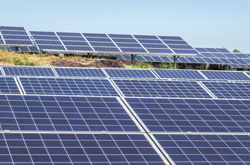Close up rows array of solar cells or photovoltaics in solar power station convert light energy from the sun into electricity alternative renewable clean energy from the sun