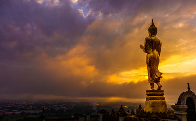 Great Golden Buddha statue at the"Wat Phra That Kao Noi" , Nan province, Thailand  with sky  Twilight time