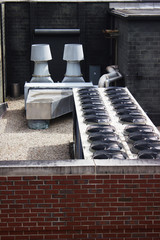 Close up of industrial cooling system on a brick building rooftop