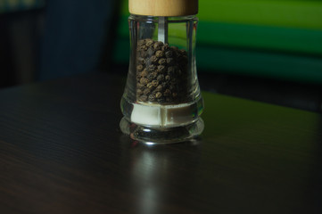 Pepper pot with spices close up background