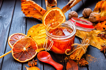 Apple-pumpkin jam with orange decorated with autumn leaves.Autumn season