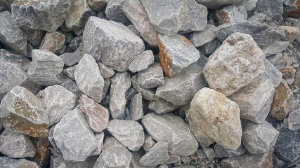 Large and small piles of limestone for use in lime kiln line  . Limestone gravel background Texture.