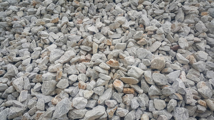 Large and small piles of limestone for use in lime kiln line  . Limestone gravel background Texture.