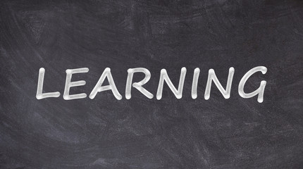 Obraz premium Learning written on blackboard
