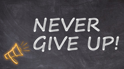 Never give up written on blackboard with megaphone