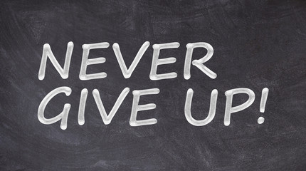 Never give up written on blackboard