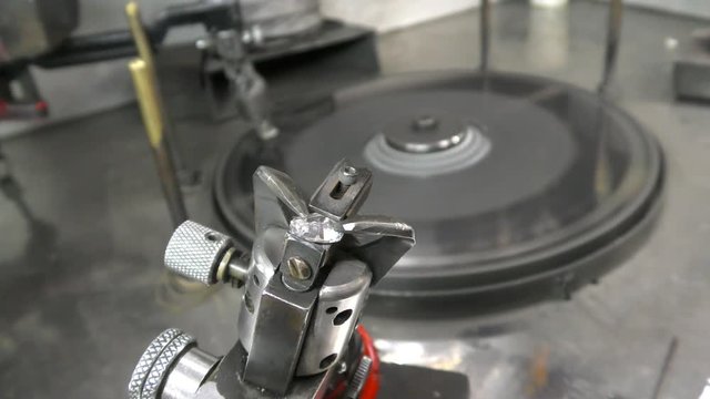 A diamond cemented on a dop is inspected